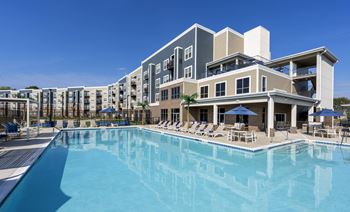 Resort-style pool with loungers and cabanas